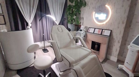 Relaxing treatment room at Medispa Naturhouse, Stevenage, England, GB, featuring a comfortable chair and calming decor.