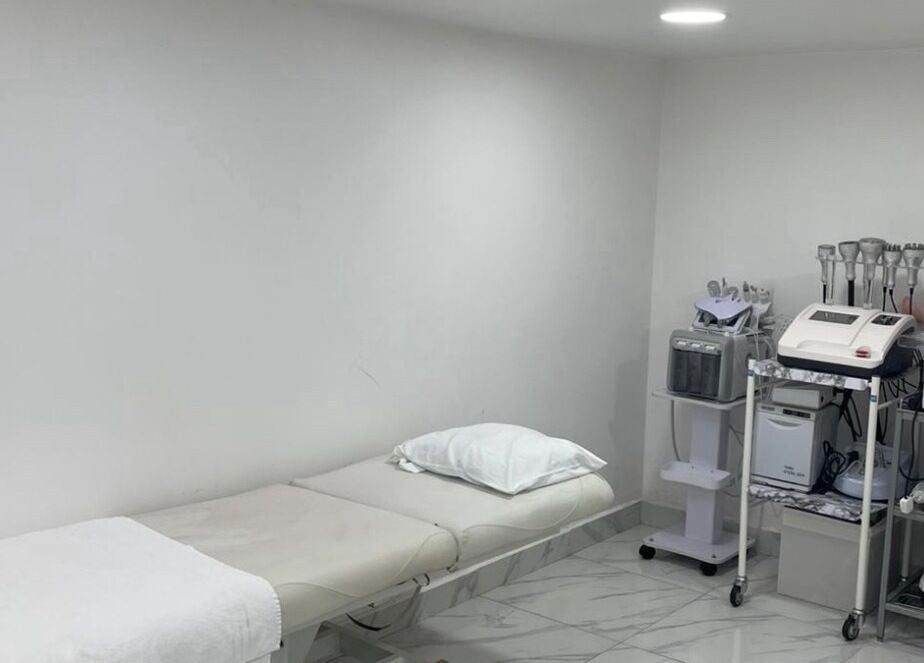 Treatment room with bed and equipment at Medispa Naturhouse, Stevenage, England, GB.