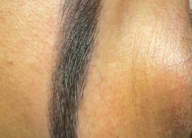 Close-up of expertly shaped eyebrow at Farnaz Beauty, London, England, GB.