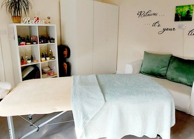 Relaxing treatment room at Harmony Wellbeing, Croydon, England, GB with a massage table and cozy decor.