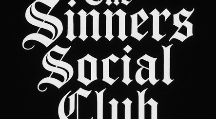 The Sinners Social Club elegant logo in black and white at Ilkeston, England, GB.