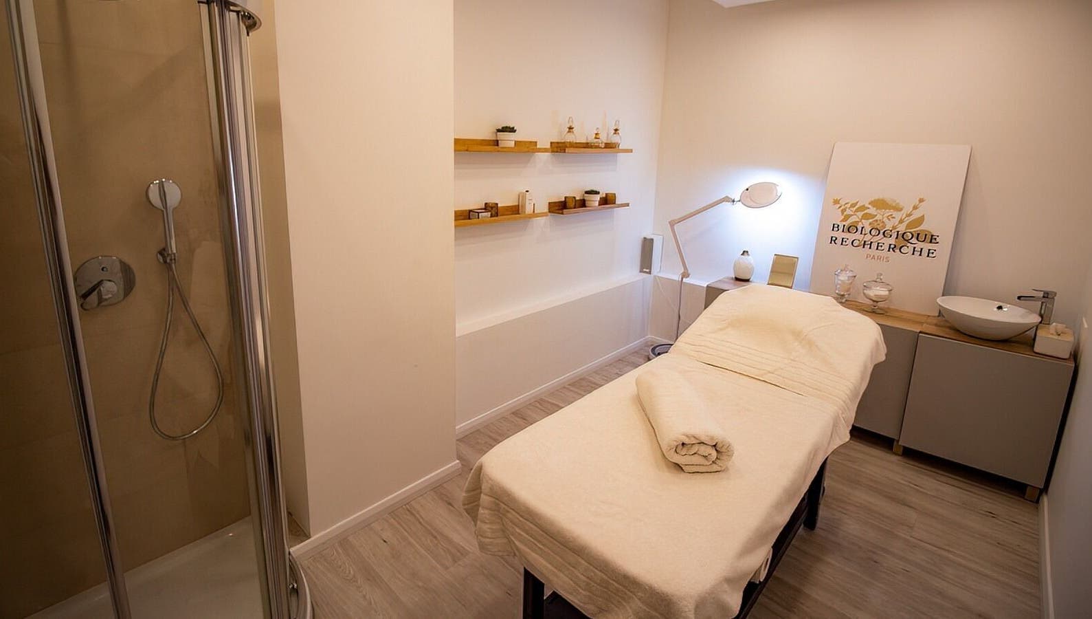 Relaxing treatment room at Studio 44 Clinic in Gibraltar, GI, featuring a massage bed and modern decor.
