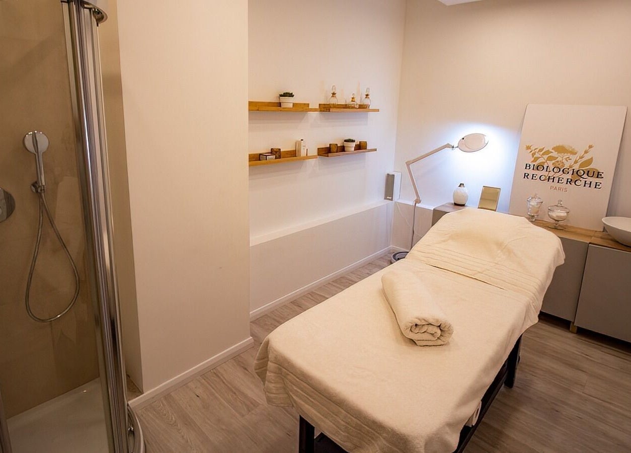 Relaxing treatment room at Studio 44 Clinic in Gibraltar, GI, featuring a massage bed and modern decor.