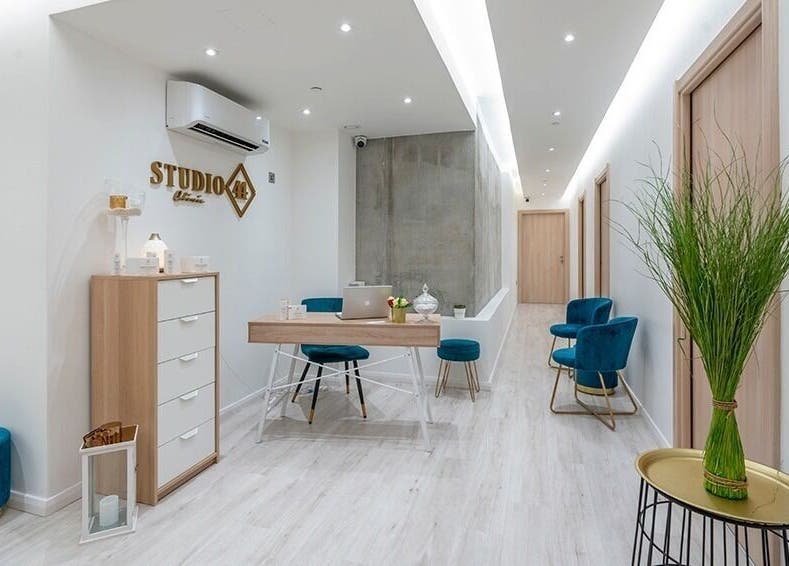Bright, modern lobby at Studio 44 Clinic in Gibraltar, GI, featuring sleek furniture and greenery.