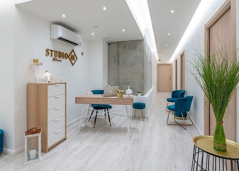 Bright, modern lobby at Studio 44 Clinic in Gibraltar, GI, featuring sleek furniture and greenery.