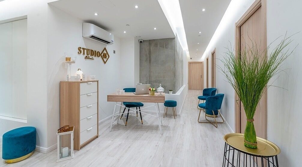 Bright, modern lobby at Studio 44 Clinic in Gibraltar, GI, featuring sleek furniture and greenery.