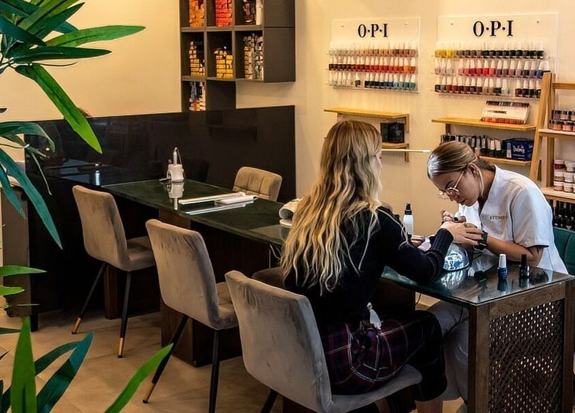 A professional manicure in process at Studio 44 Clinic, Gibraltar, GI, featuring nail polish selection.