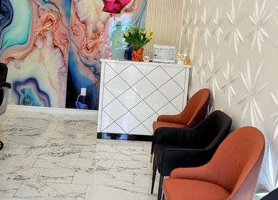 Stylish reception area at Soul Heaven Spa, Shelburne, Ontario, CA with artistic wall design and plush chairs.