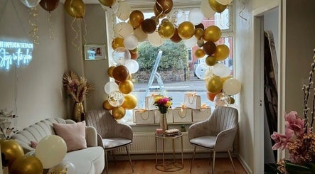 Elegant waiting area at Hair by Jess Marie, Great Sankey, England, GB with festive balloons and chic decor.
