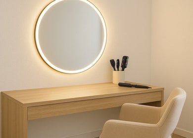 Sophisticated makeup station at The Beauty Spot, Tunapuna, features a sleek mirror and chair for a luxury experience.
