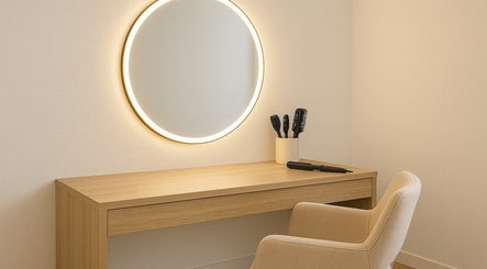 Sophisticated makeup station at The Beauty Spot, Tunapuna, features a sleek mirror and chair for a luxury experience.