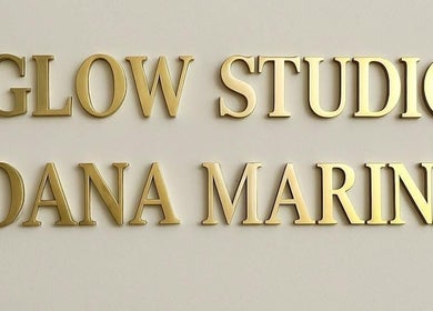 GlowStudio.OanaMarina golden sign in Abingdon, England, GB reflecting luxury and elegance.