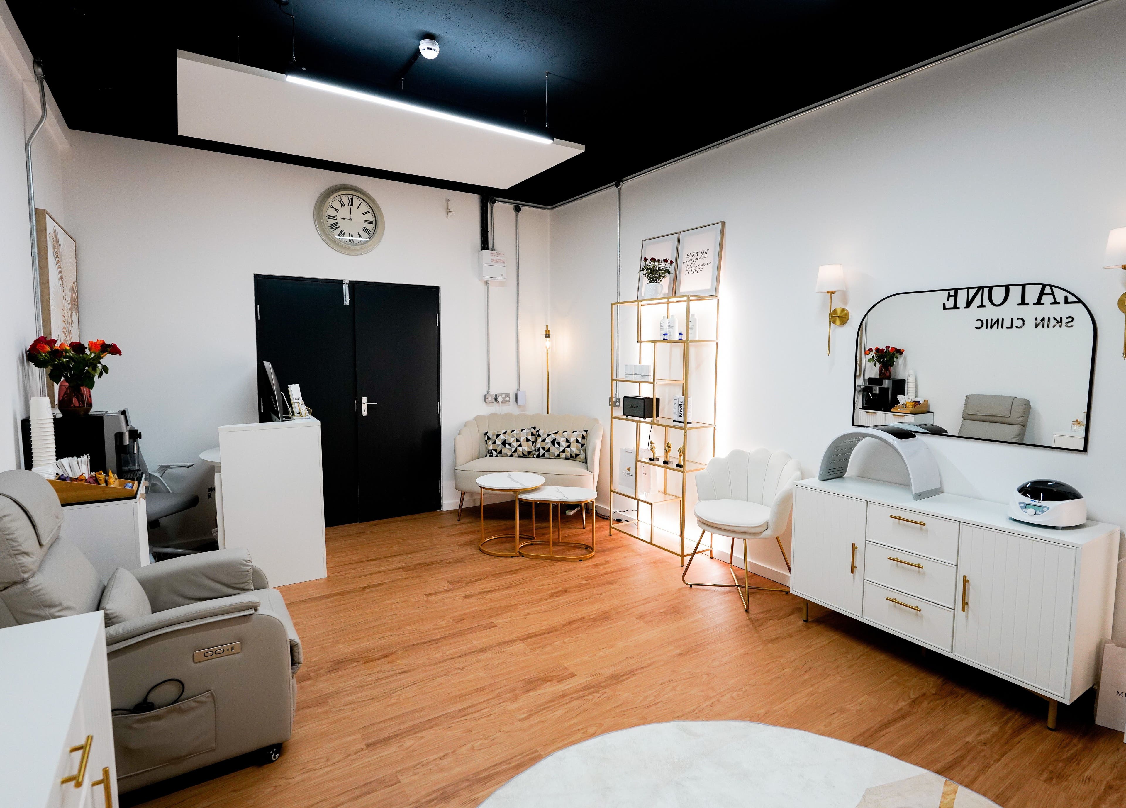 Chic interior of Melatone Skin Clinic, London, England, GB featuring cozy seating and modern decor.