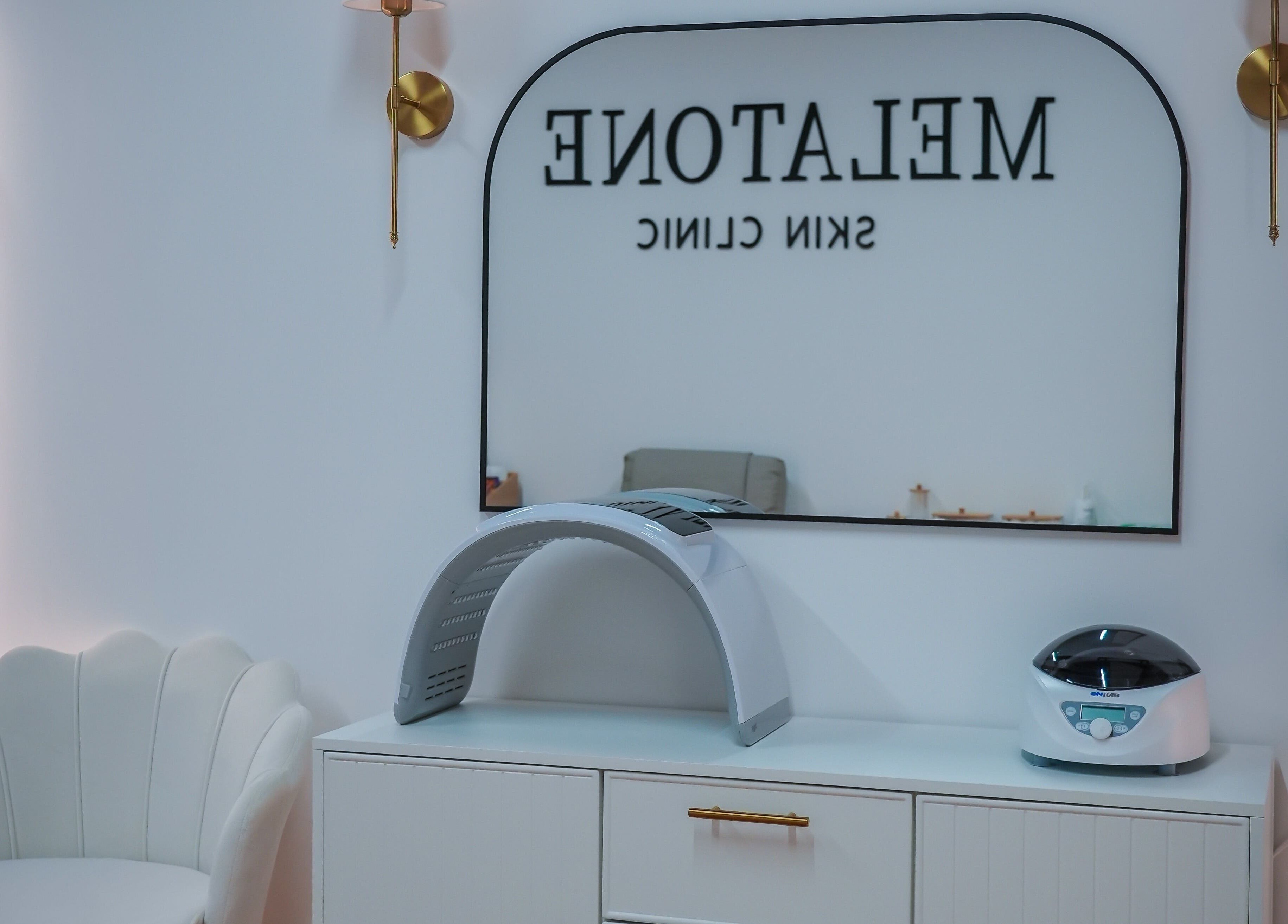 Modern treatment room at Melatone Skin Clinic, London, England, GB, showcasing elegant design and equipment.