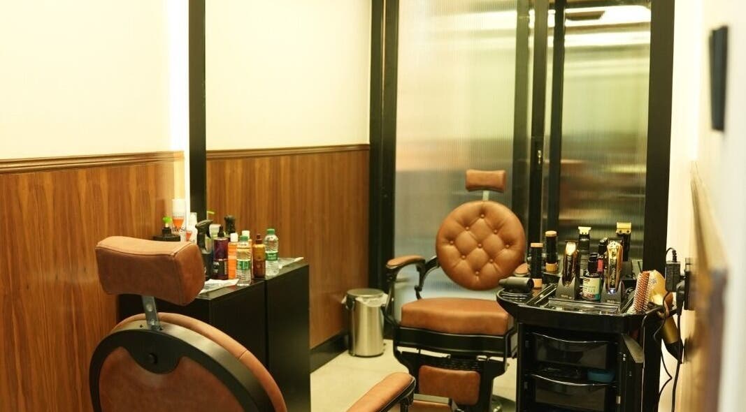 Sleek barber room at Noble Gents, Riyadh, Riyadh Province, SA, featuring plush chairs and grooming tools.