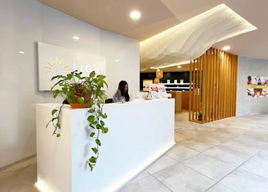 Bright, modern reception area at Contourista London with plants and a welcoming desk in London, England, GB.