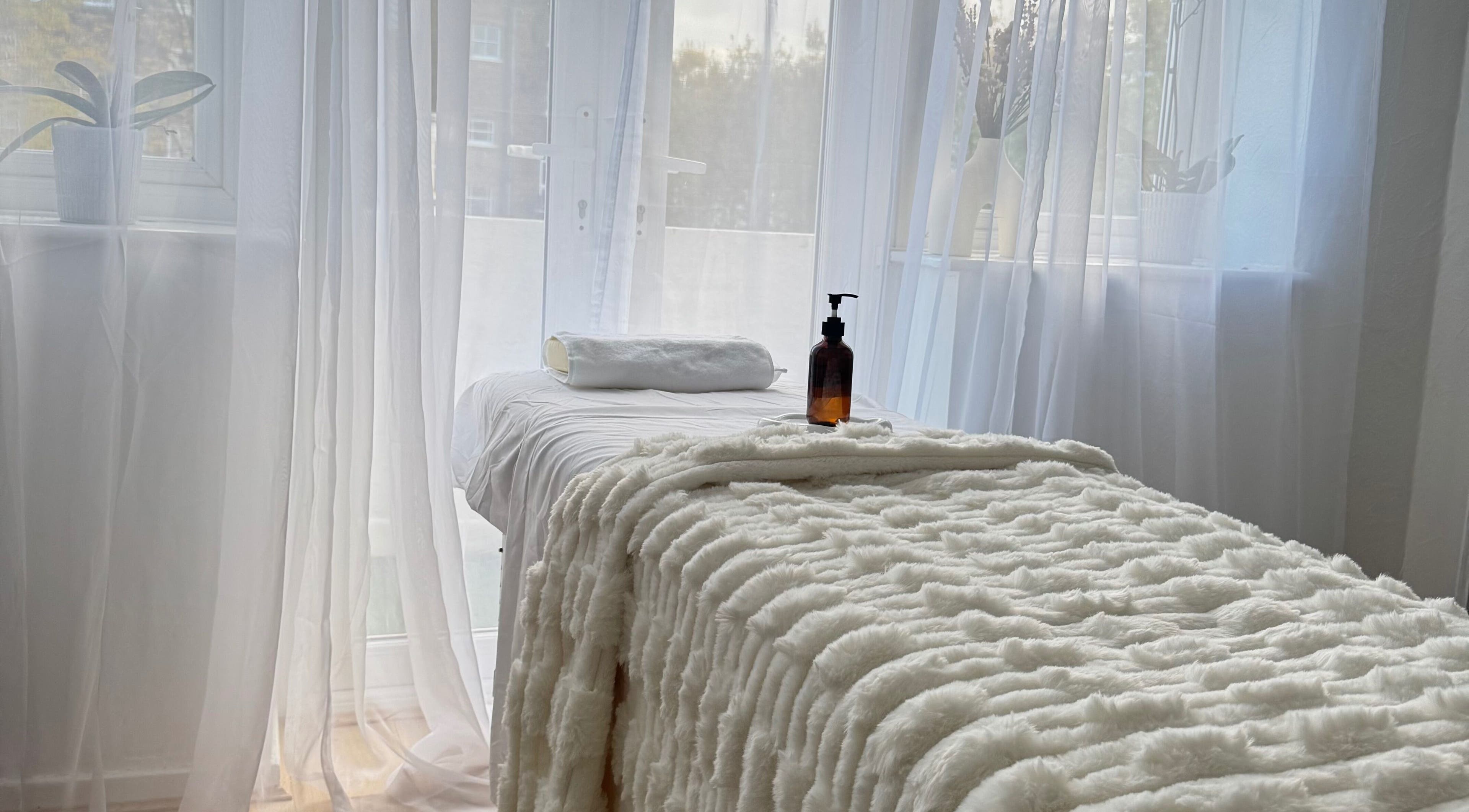 Peaceful treatment room at Contourista London - Mobile Services, London, England, GB with plush bedding.