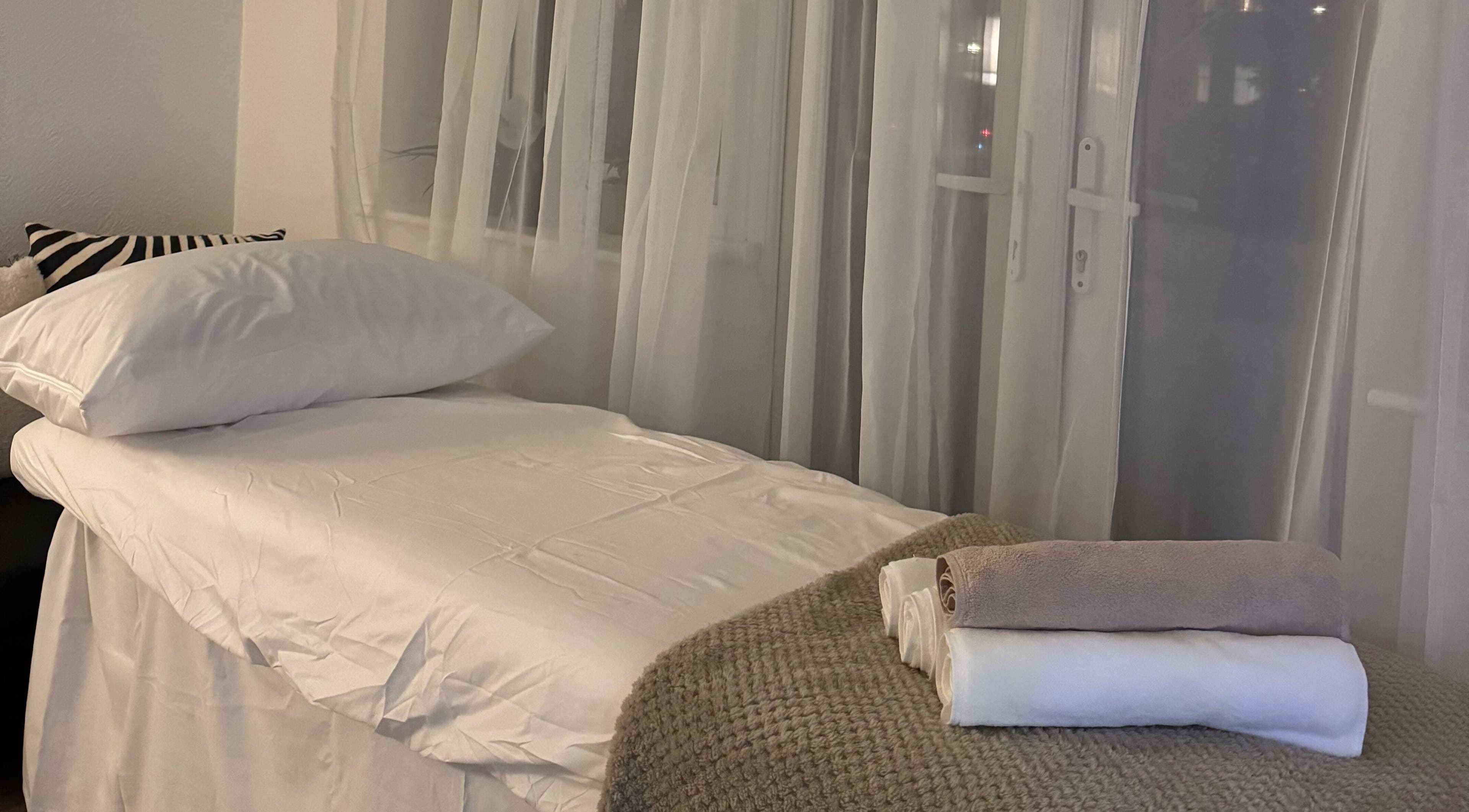 Cozy spa bed setup at Contourista London - Mobile Services, London, England, GB with soft linens and towels.
