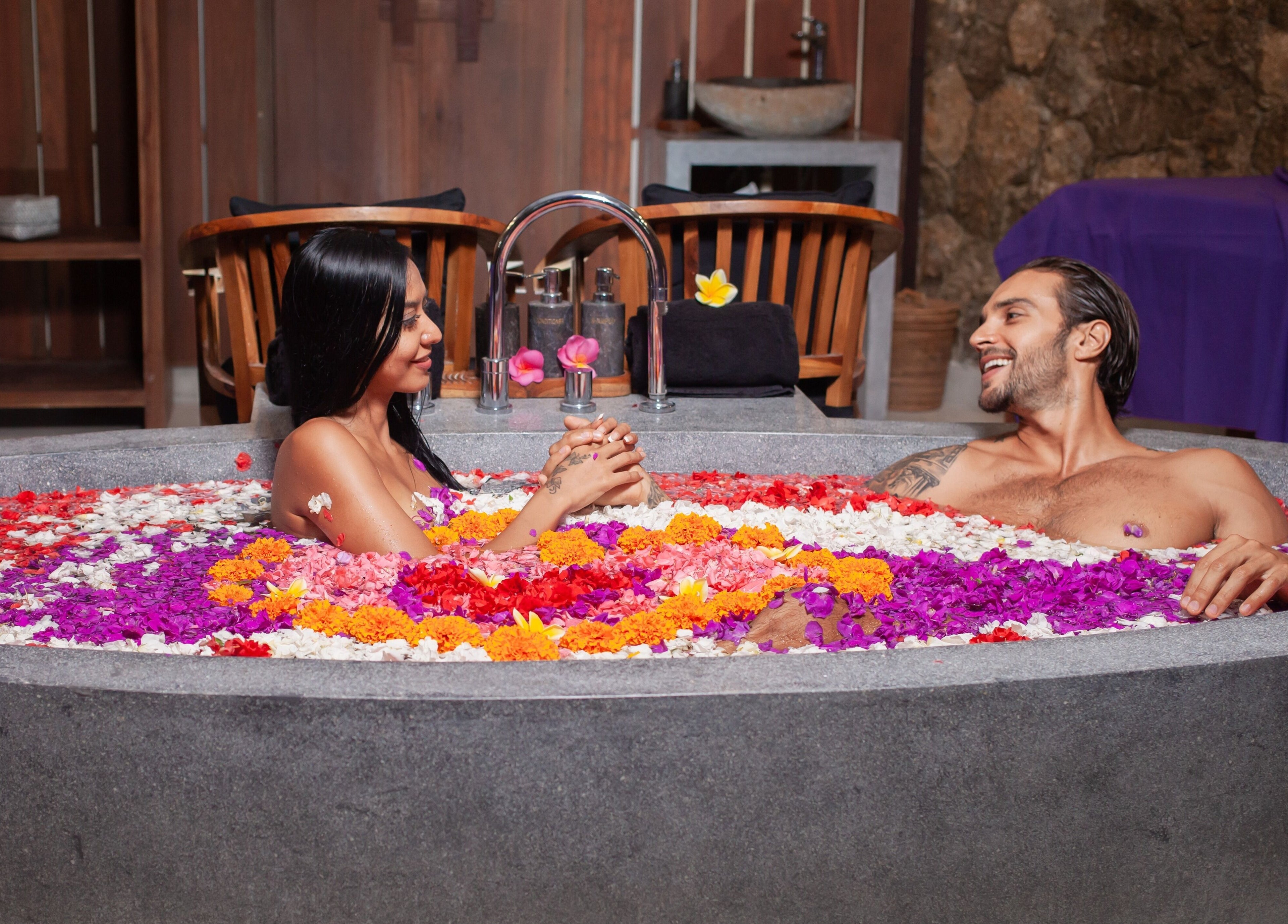 Couple enjoying floral bath at Darbha Spa Ubud, Bali, Bali, ID, offering serene wellness experience.