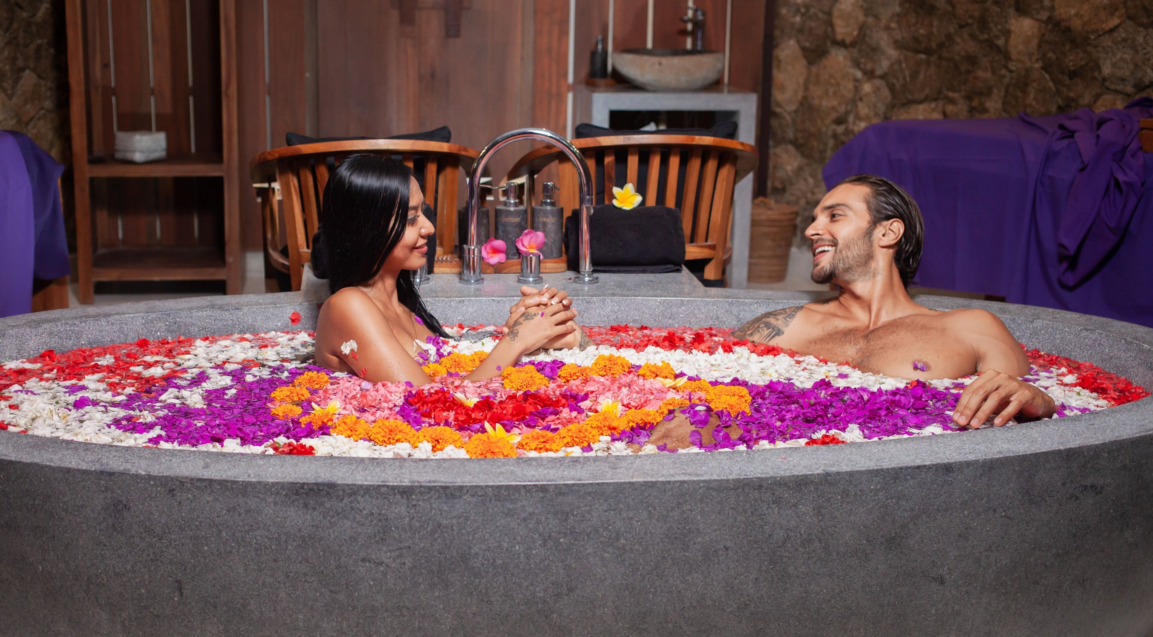 Couple enjoying floral bath at Darbha Spa Ubud, Bali, Bali, ID, offering serene wellness experience.