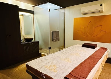 Tranquil spa room at Isa Spa Hopefarm Whitefield, Bengaluru, Karnataka, IN, with a massage bed and modern decor.
