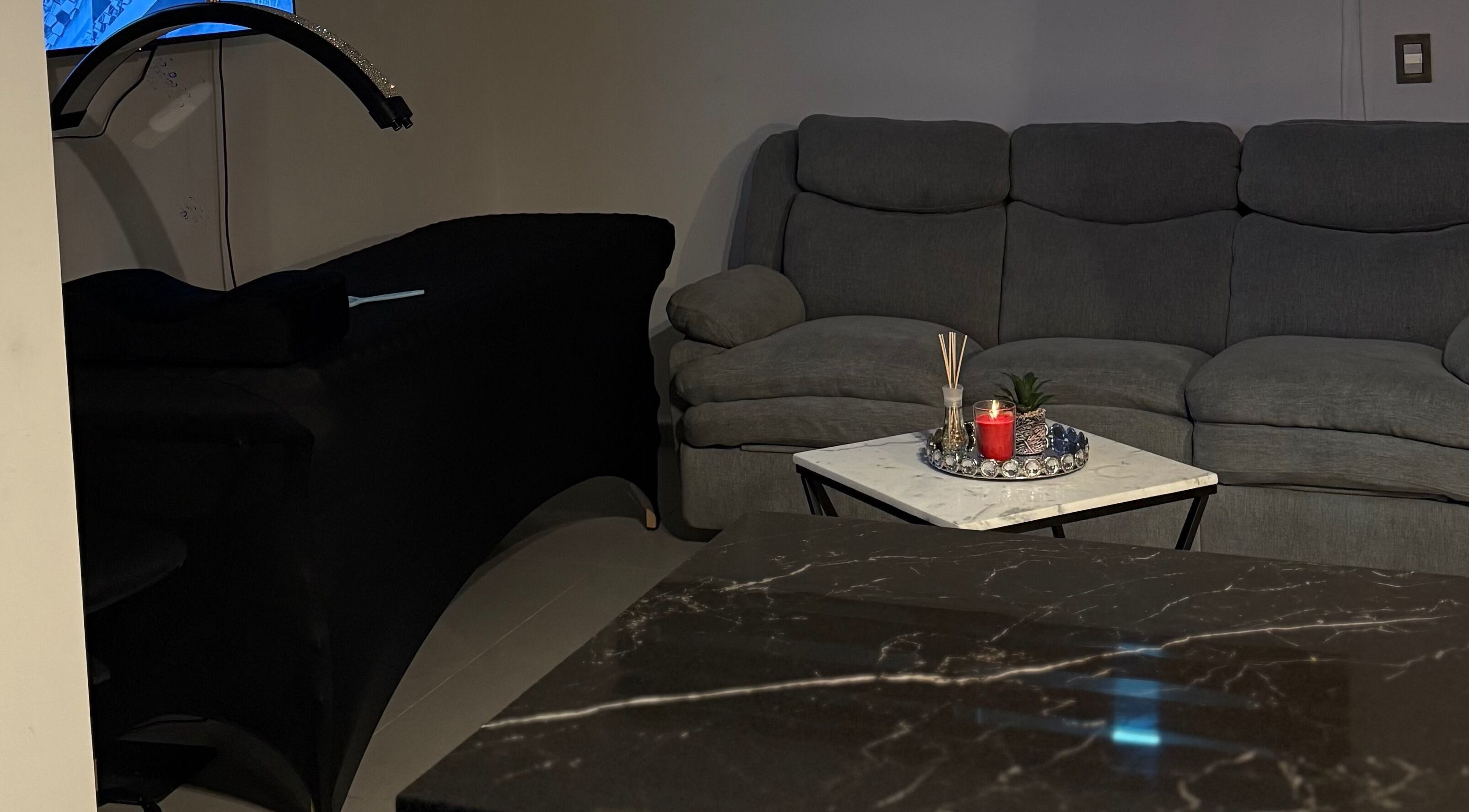 Cozy lounge at Fernanda Martínez, Ciudad Del Carmen, Campeche, MX with sofa and massage table.