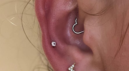 Stylish ear piercing at KB Piercings & Pearly Whites, Garforth, England, GB, showcasing elegant jewelry.