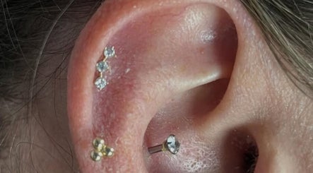 Elegant ear piercings with gemstones at KB Piercings & Pearly Whites in Garforth, England, GB.