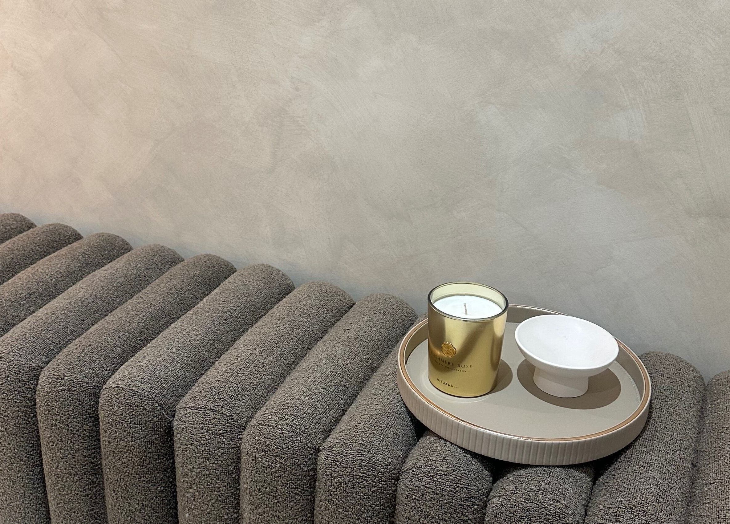 Luxurious candle and bowl on chic textured seating at HBA HAIR, Leicester, England, GB.