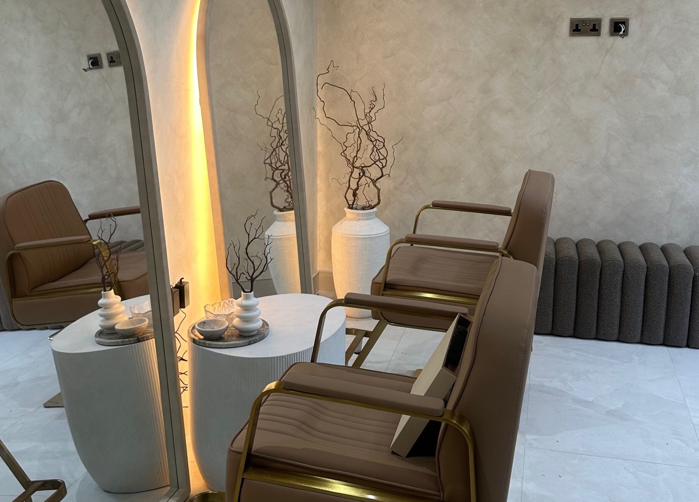 Elegant salon seating area at HBA HAIR, Leicester, England, GB with modern decor.