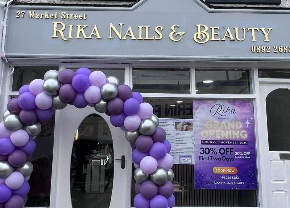 Rika Nails & Beauty in County Louth with a festive balloon arch and grand opening sign outside.