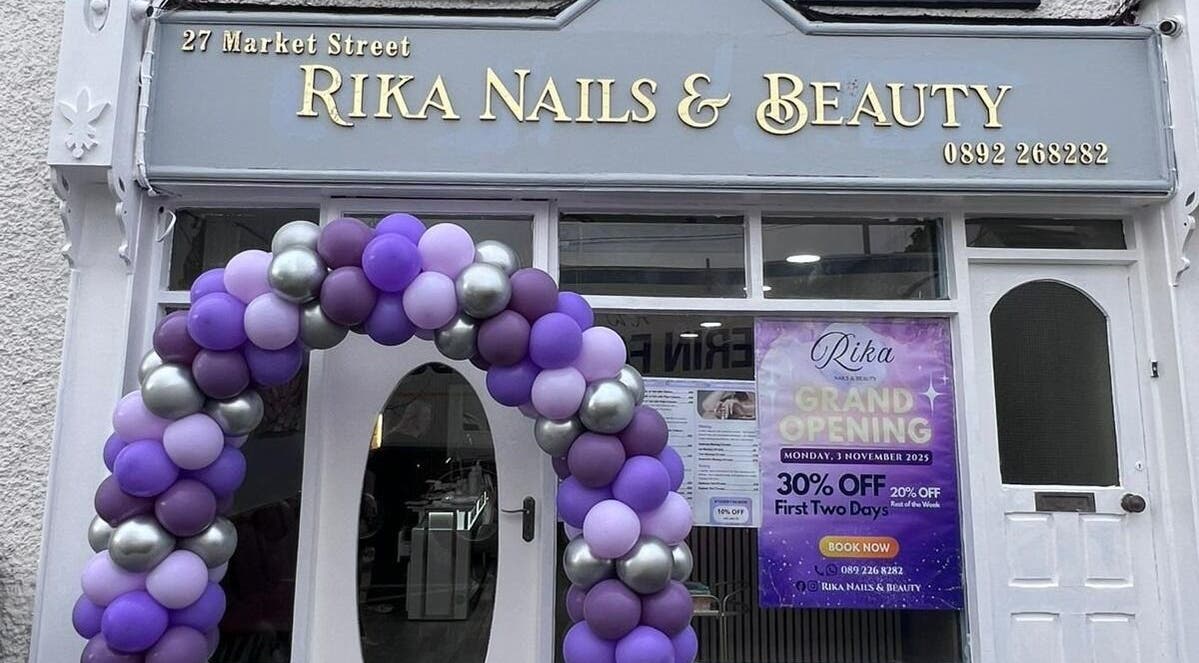 Rika Nails & Beauty in County Louth with a festive balloon arch and grand opening sign outside.