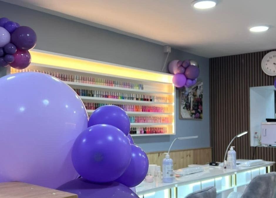 Rika Nails & Beauty in County Louth with purple balloons and nail polish display for a festive atmosphere.