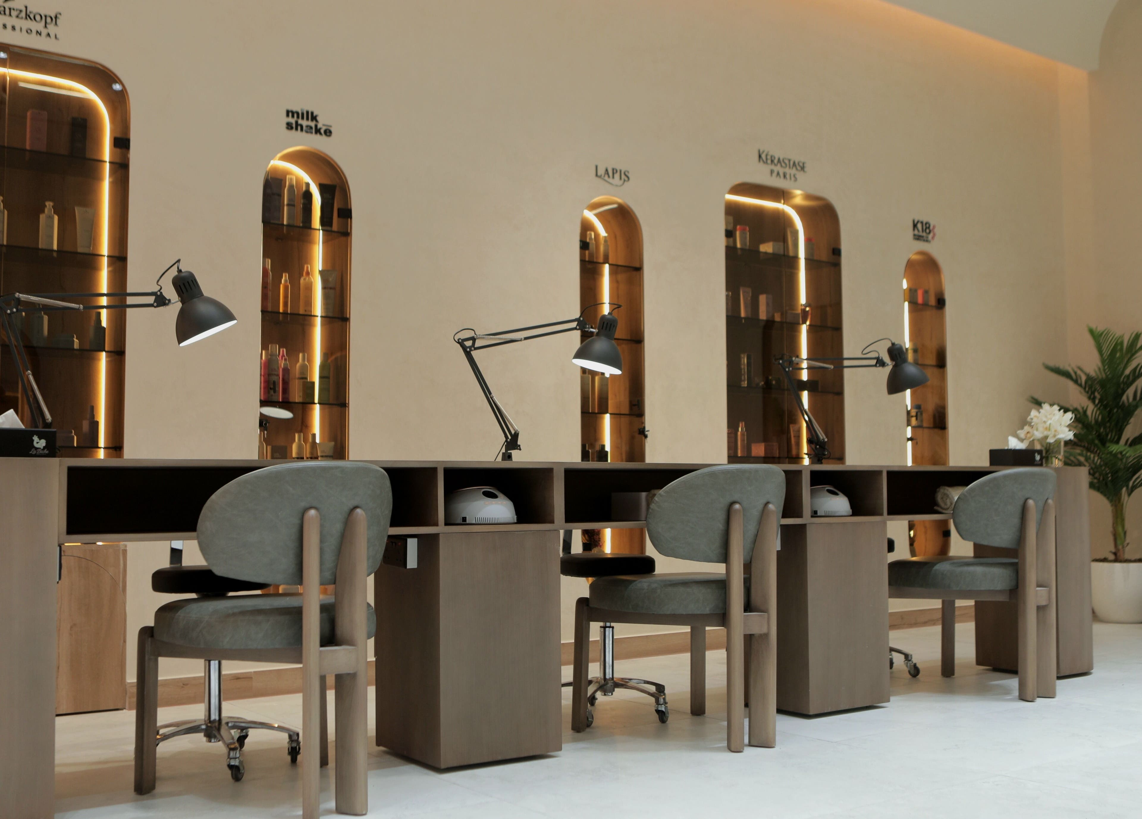 Modern workspace at La Biche Beauty Salon in Abu Dhabi, AE featuring stylish chairs and elegant decor.