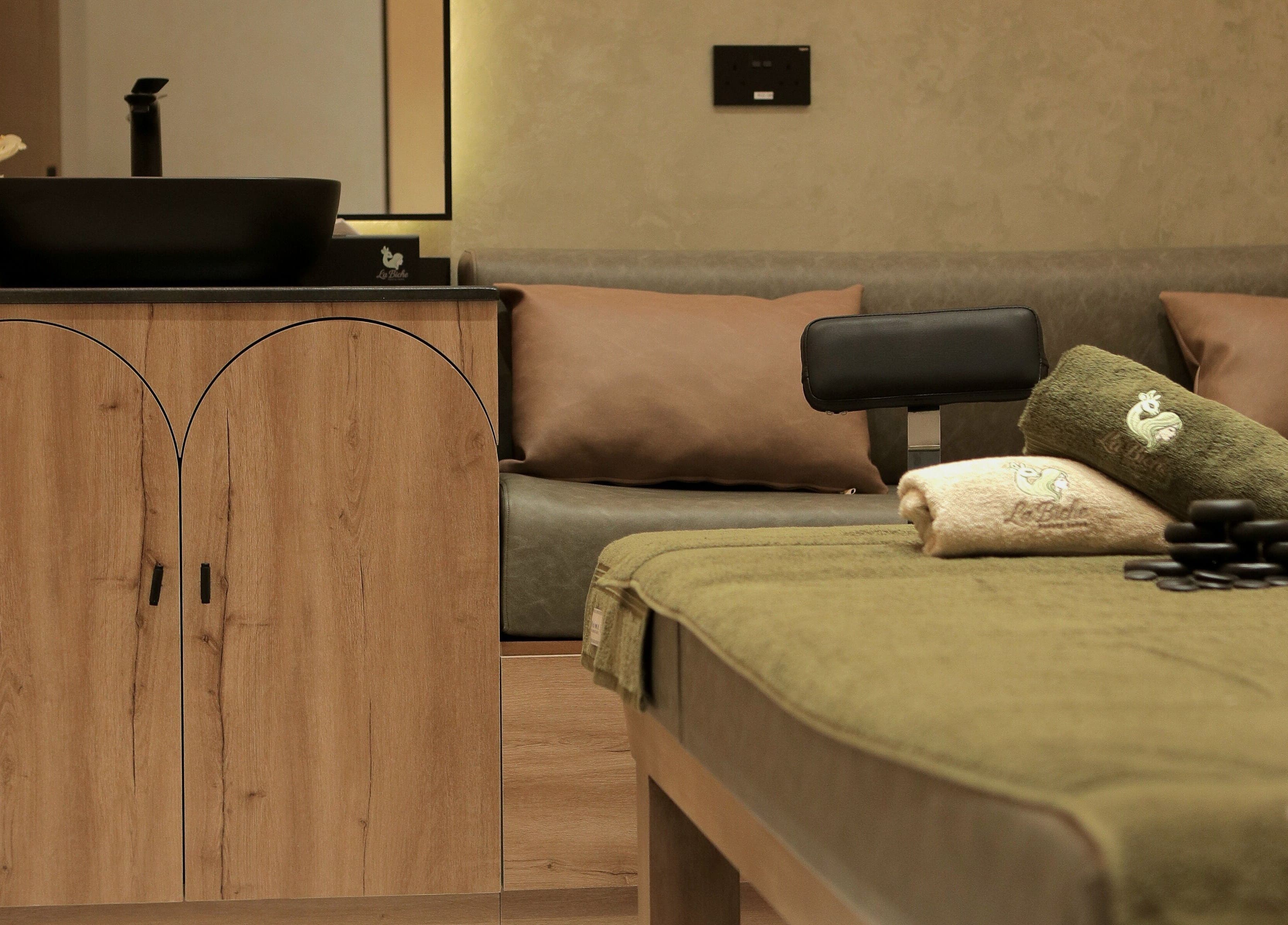 Massage table and towels at La Biche Beauty Salon, Abu Dhabi, Abu Dhabi, AE, offering a relaxing atmosphere.