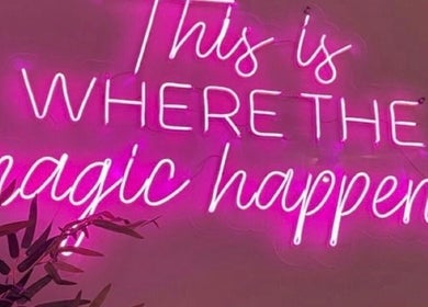 Pink neon sign reading 'This is where the magic happens' at Ambitious Beauty Bar, Virginia, Virginia, US.