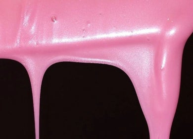 Vibrant pink nail polish dripping at Ambitious Beauty Bar in Virginia, Virginia, US, creating a striking visual.