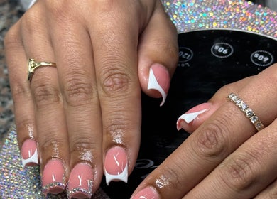 Elegant nail art at Ambitious Beauty Bar in Virginia, Virginia, US. Stylish pink and white manicure with rhinestones.