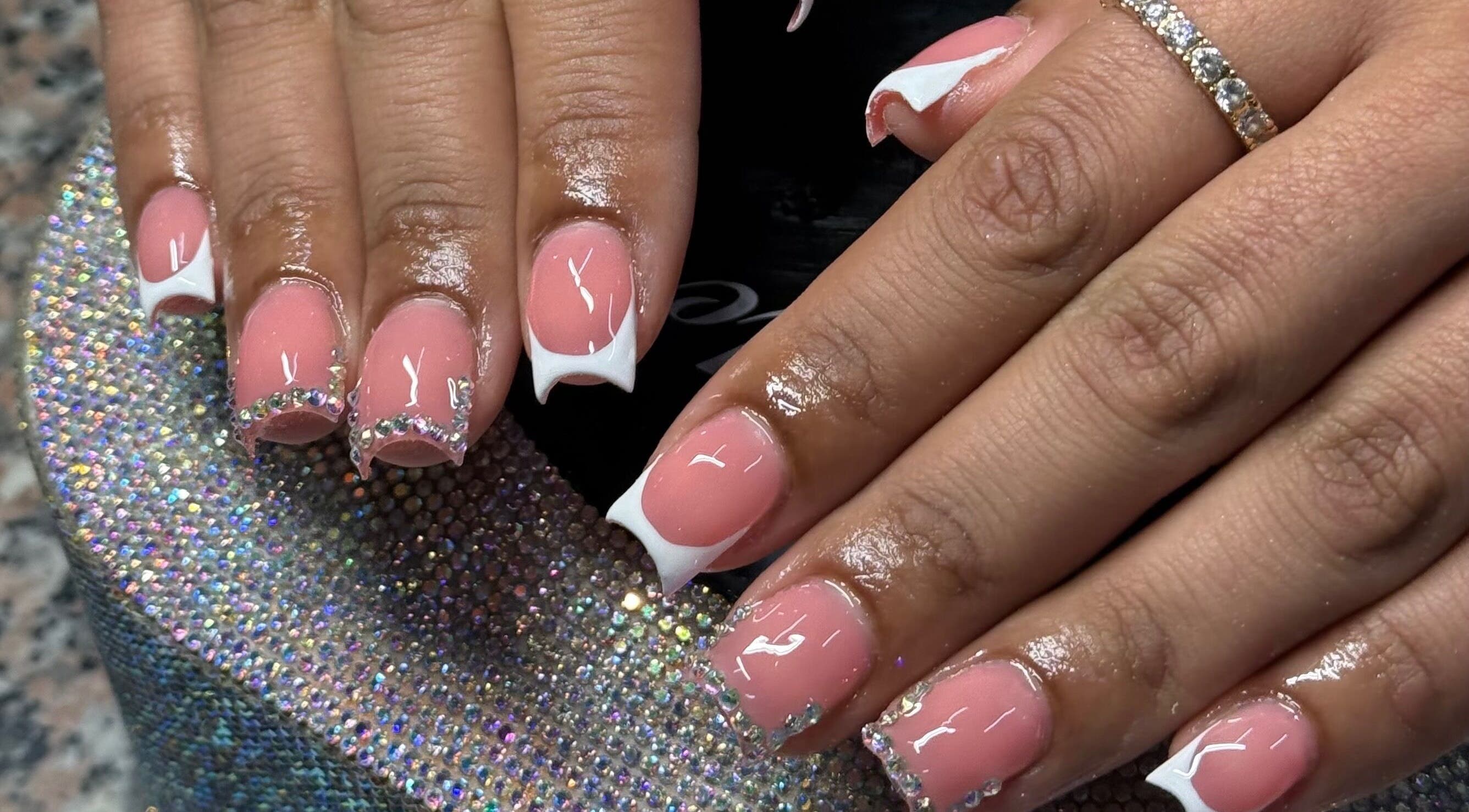 Elegant pink and white embellished nails at Ambitious Beauty Bar, Virginia, Virginia, US.