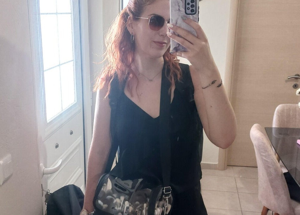 A woman takes a mirror selfie in stylish attire at Glow Myth by Maria Kourkouvelou, Featherstone, England, GB.