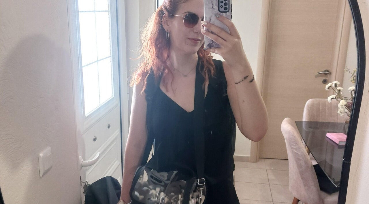 A woman takes a mirror selfie in stylish attire at Glow Myth by Maria Kourkouvelou, Featherstone, England, GB.