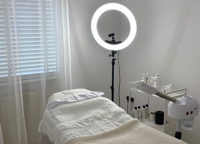 Serene treatment room at SknandSculpt, Ely, England, GB, featuring a cozy bed and skincare products.