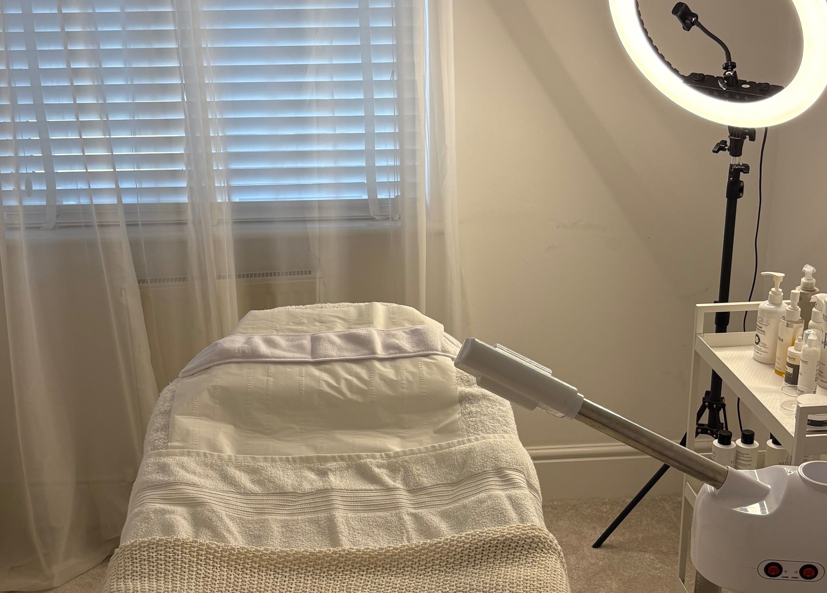 Peaceful treatment room at SknandSculpt in Ely, England, GB with massage table and skincare equipment.