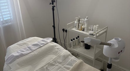 Tranquil treatment room at SknandSculpt, Ely, England, GB, featuring a massage table and skincare products.