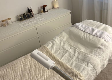 Relaxing treatment room at SknandSculpt in Ely, England, GB, featuring a cozy bed and soothing decor.