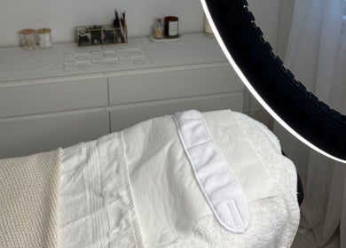 Peaceful treatment room at SknandSculpt, Ely, England, GB, featuring a prepared treatment bed and soft lighting.