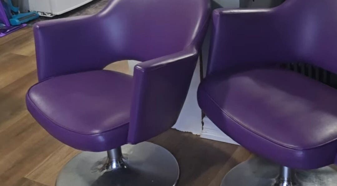 Two sleek purple chairs at Scissors & Serums, Whitby, Ontario, CA enhancing salon's modern ambiance.