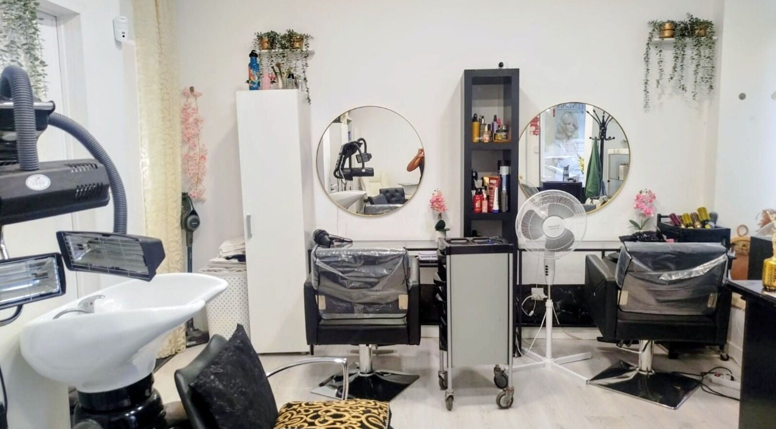 Chic beauty salon interior at Patricia Oliveira, Lisboa, Lisboa, PT. Modern chairs, mirrors, and styling tools.