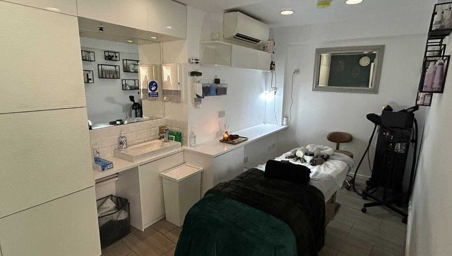 Elegant treatment room at Innior Ltd, Teddington, England, GB, featuring a massage table and soothing decor.