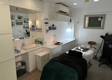 Elegant treatment room at Innior Ltd, Teddington, England, GB, featuring a massage table and soothing decor.